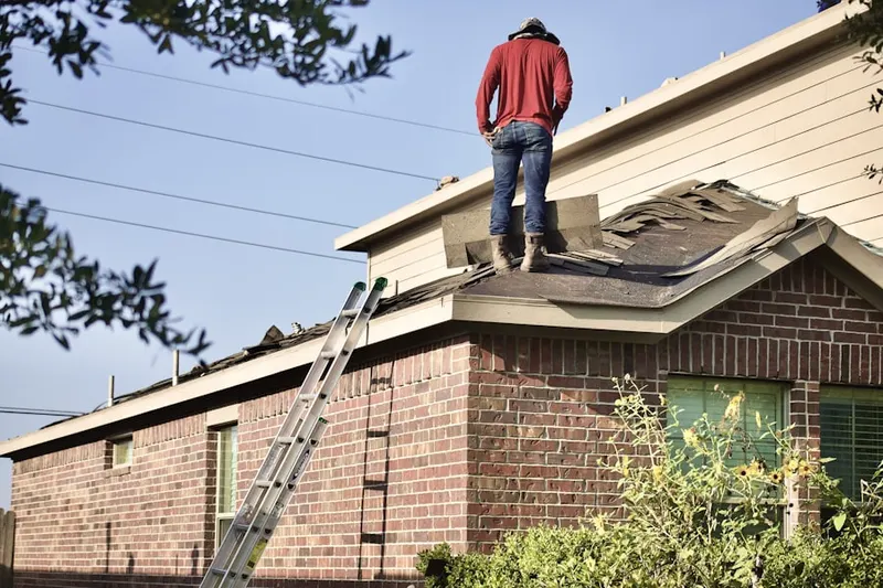 Professional roofer working on a residential roof in Leisureville
